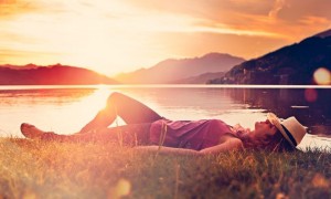 girl lying in sunset on a meadow