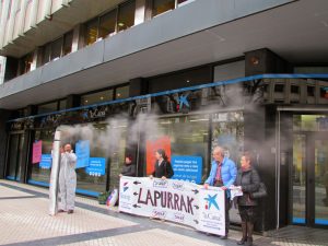 Koordinadorako kideak protestan La Caixa bankuaren atarian. (Argazkia: Errausketarik Ez)